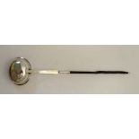 A 19thC white metal toddy ladle with gilded bowl and whale bone twist handle. 14 1/2" long