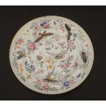 An 18thC famille rose Oriental style plate. Decorated with insects and butterflies surrounded by