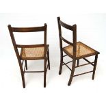 A pair of stained beech caned seated bedroom chairs. each standing 33" high  CONDITION: Please