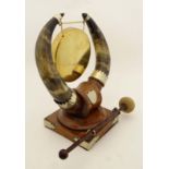 A late Victorian brass Gong , stand and beater with comb decorated oak base , the mounts formed from