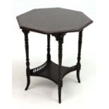 A 19thC octagonal 2-tier ebonised occasional table with galleried under tier and ring turned legs.