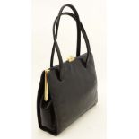 A black leather handbag by Ackery London, with black fabric lining. Approx 9 1/4 wide. 7 3/4 height,