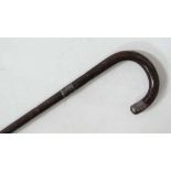 A 1920's peacock wood crook handle walking cane with HM silver tip and collar, lightly engraved.