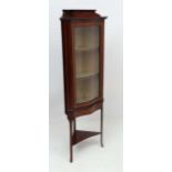 A most unusual Edwardian cross banded and inlaid mahogany glazed front corner cabinet with