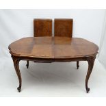 A 20thC  Italian extending walnut dining table together with 6 matching cane back overstuffed dining