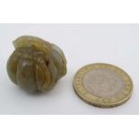 A carved russet jadeite figure of a pumpkin and caterpillar 1" wide  CONDITION: Please Note -  we do