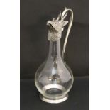 A 20thC novelty claret jug, the clear glass body with silver plated mounts and handle, the head