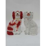 Two Victorian Staffordshire Spaniels, facing left and right, comprising one with iron red detail,