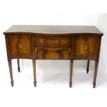 An early 20thC mahogany serpentine shaped 6-legged sideboard with central undertier drawer  56" wide