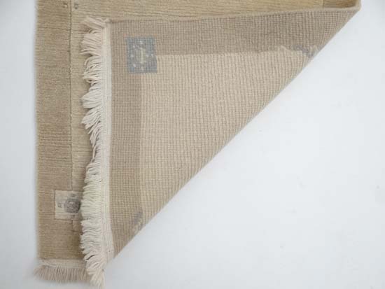 Carpet / Rug : a Woollen Rug in beige with a tan border with fringe to ends 
Approximately 41 1/2 - Image 13 of 13