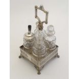 A silver plate 4 bottle cruet stand by Walker & Hall. The stand of squared form with galleried