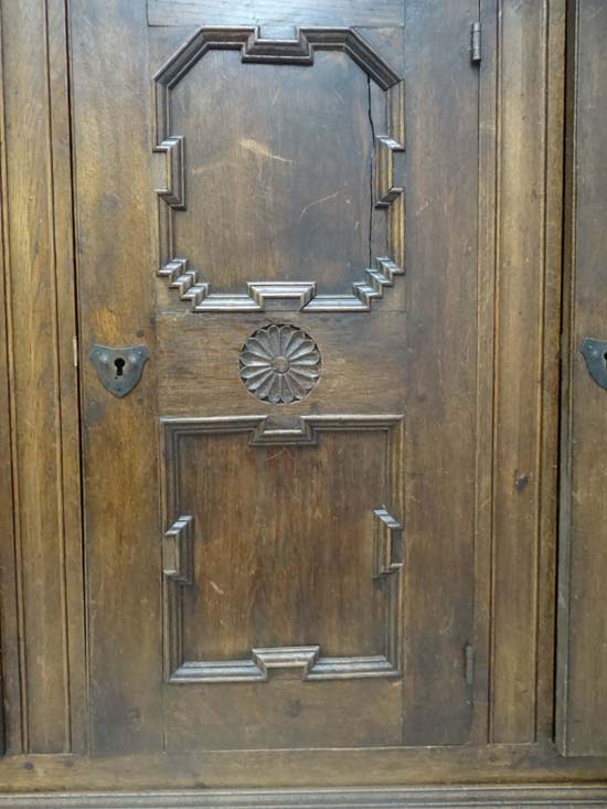 An early 20thC German oak 3 door cupboard with geometric like framed panelling, the doors opening to - Image 4 of 20