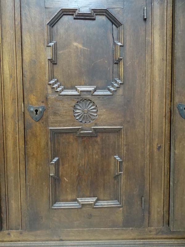 An early 20thC German oak 3 door cupboard with geometric like framed panelling, the doors opening to - Image 7 of 20