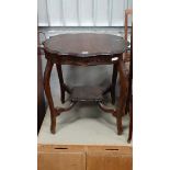 An Edwardian mahogany serpentine sided occasional table of 2 tiers CONDITION: Please Note -  we do