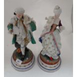 A pair of Continental porcelain figures depicting a male and female in elegant 18thC dress, each