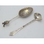 A Continental spoon with embossed decoration together with a small ladle (2) CONDITION: Please