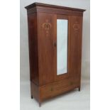 An Edwardian inlaid and strung mahogany double wardrobe with central bevelled edge mirror to door