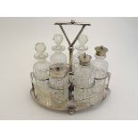 A silver plate 6 bottle cruet stand by HG Long & Co . The stand of ovoid form with shield to sides