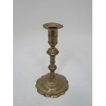 A c.1800 turned brass candlestick with petal sconce and spun base. 7 3/4" high CONDITION: Please