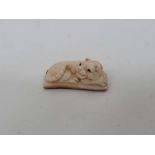 An old netsuke formed as a recumbent tiger - signed to edge CONDITION: Please Note -  we do not make