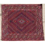 Rug / Carpet : A Turkish handmade woollen rug with a radiating diamond design on a mainly claret red