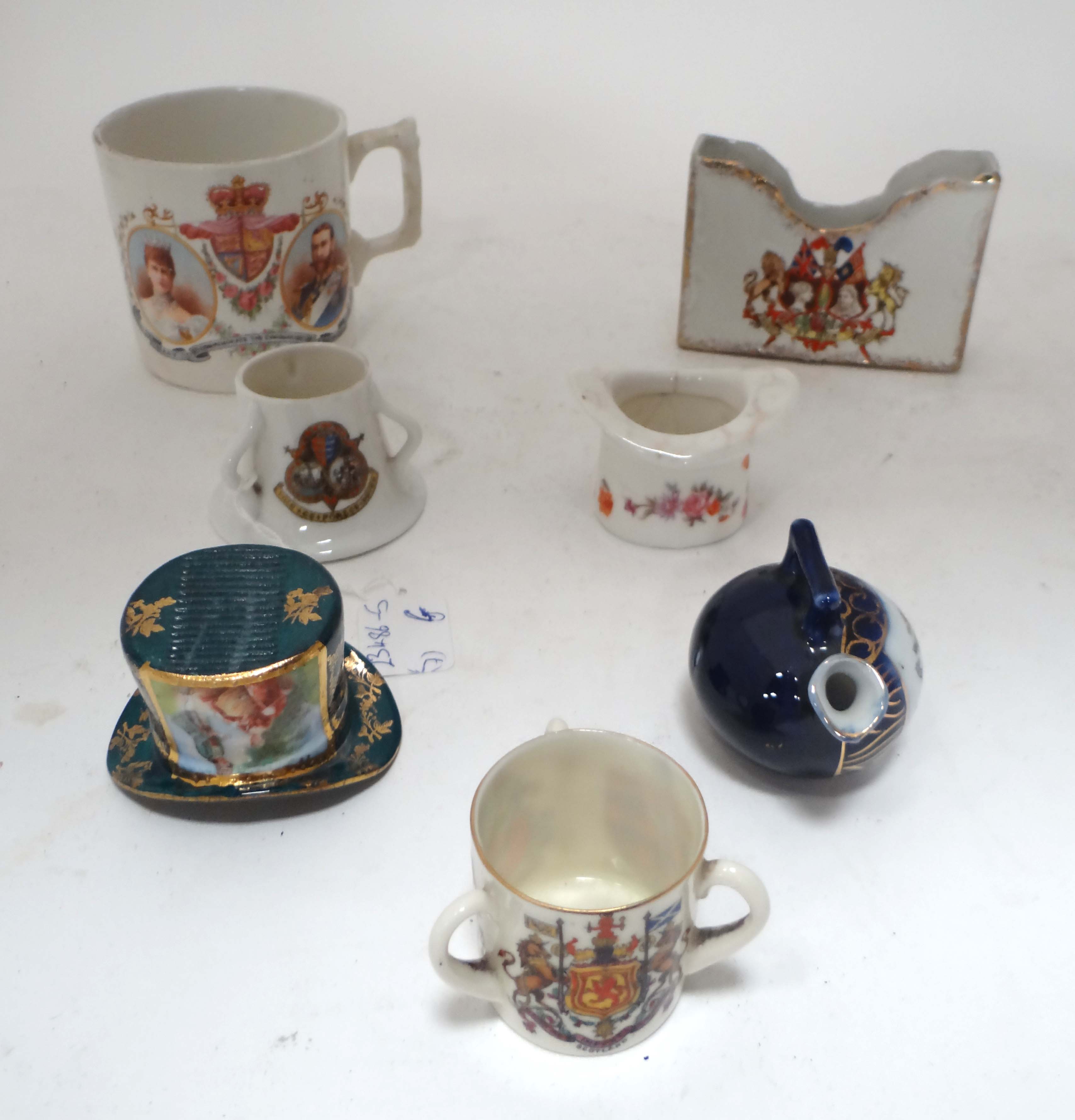 Assorted items comprising matchstriker, crested ware , 1911 commemorative mug and Queen Victoria