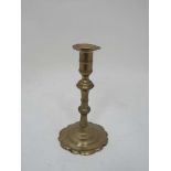 A c.1800 turned brass candlestick with petal sconce and spun base. 7 3/4" high CONDITION: Please