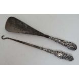 A silver handle shoe horn and button hook CONDITION: Please Note -  we do not make reference to