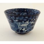 A 19thC blue and white tea bowl , transfer decorated with images of figures outside a cottage. 3 3/
