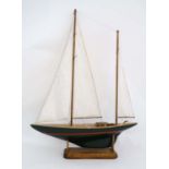 An early 20thC twin masted pond yacht on oak stand 29" long  x 29 1/4" high  CONDITION: Please