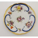 An English late 18th / early 19thC hand painted plate, decorated with polychrome floral and