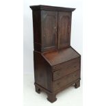 An 18thC George I country made oak bureau bookcase with hinged well section. 37" wide x 71" high x
