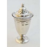 A silver pepperette of pedestal urn form. Hallmarked Sheffield 1921 maker Roberts & Belk and