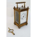 Carriage Clock : a brass filigree cased 5 bevelled glass carriage clock ( timepiece) , with reeded
