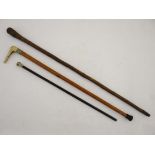 A Victorian mallacca cane with antler handle and embossed brass collar toegtehr with a swagger stick