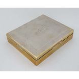 A HM silver table top cigarette case with engine turned decoration and wood lined interior.
