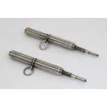 A pair of white metal pencil twisting to centre to reveal pencil section to one end. 2" long (