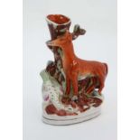 A Staffordshire flat backed spill vase with fox and goose on an oval base. 19thC. 8 3/4'' high.