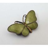 Norwegian Silver : A silver gilt brooch formed as a butterfly with lime green guilloché enamel
