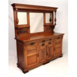 A late 19thC oak mirror back sideboard with bevelled mirrors over a base of 4 drawers and 4 cupboard