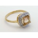 A yellow metal ring set with unusual watermelon tourmaline bordered by diamonds (tourmaline