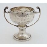 A silver trophy cup of pedestal form with twin handles and engraved ' Mopes Farm Gymkhana 1947