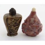 Chinese snuff bottles : A carved red soapstone snuff decorated with fish together with a carved horn