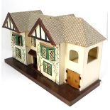 Toy: A Circa 1930's Tri-ang Dolls House with hand painted decoration , front opening double doors