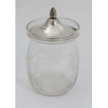 A glass preserve jar with etched floral and foliate decoration and silver top hallmarked London 1922