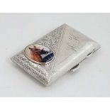 A silver cigarette case of shaped form with engraved decoration and gilded interior. Hallmarked