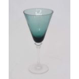 A set of 4 large pedestal wine glasses, the green glass faceted conical form bowls on clear stems