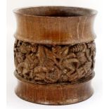 An African turned wooden pot with banded detail depicting figures at work etc. 7" high CONDITION: