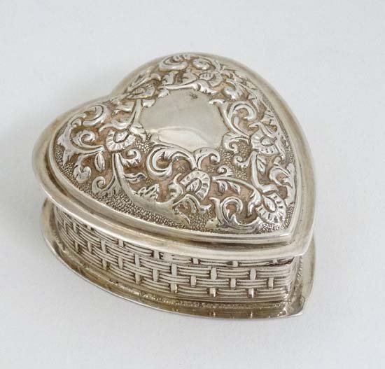 A silver dressing table pot of heart form with hinged lid and gilded interior. Hallmarked  London