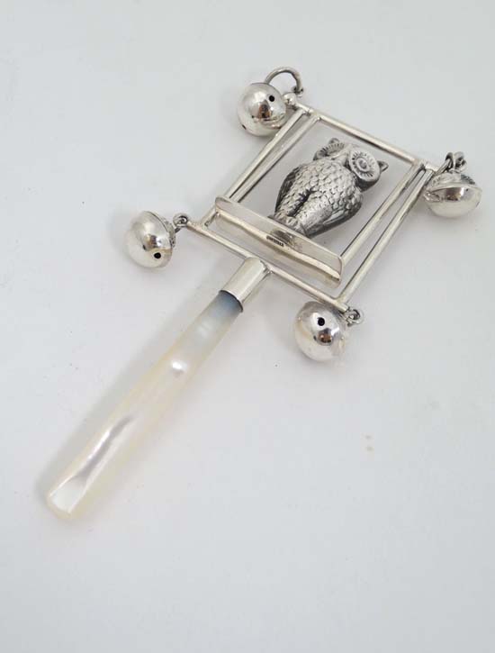 A white metal child's rattle decorated with owl and bells with mother of pearl teether handle. - Image 3 of 3
